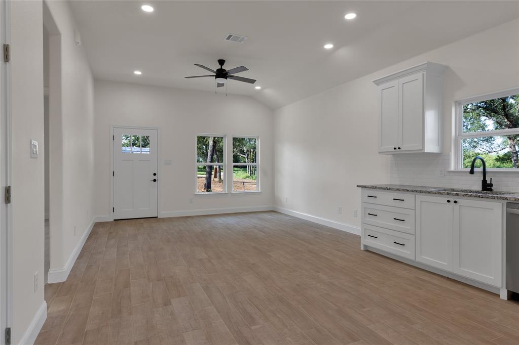 815 Southwest 28th Street Mineral Wells, TX 76067 - Photo 20 of 40 an empty room with windows and cabinet