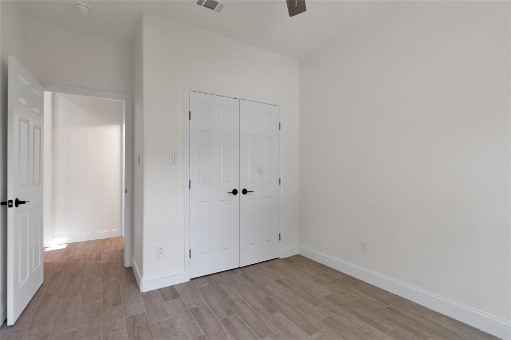 815 Southwest 28th Street Mineral Wells, TX 76067 - Photo 31 of 40 a view of an empty room with wooden floor