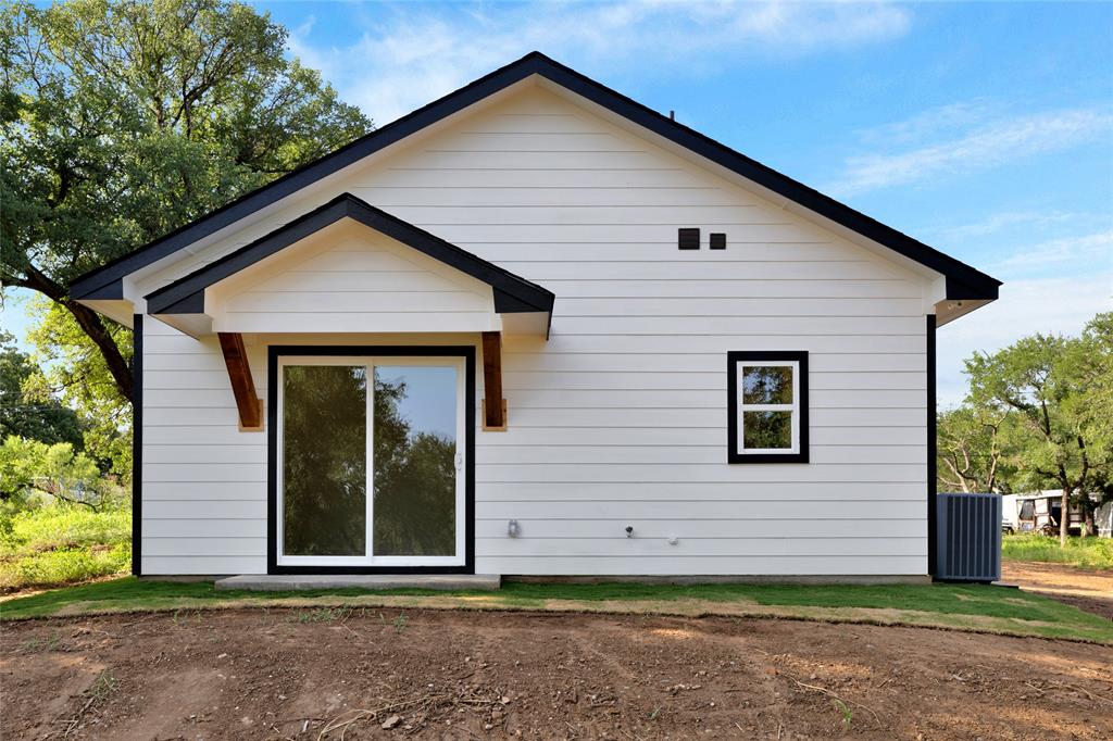 815 Southwest 28th Street Mineral Wells, TX 76067 - Photo 38 of 40 a view of a house with a yard and garage