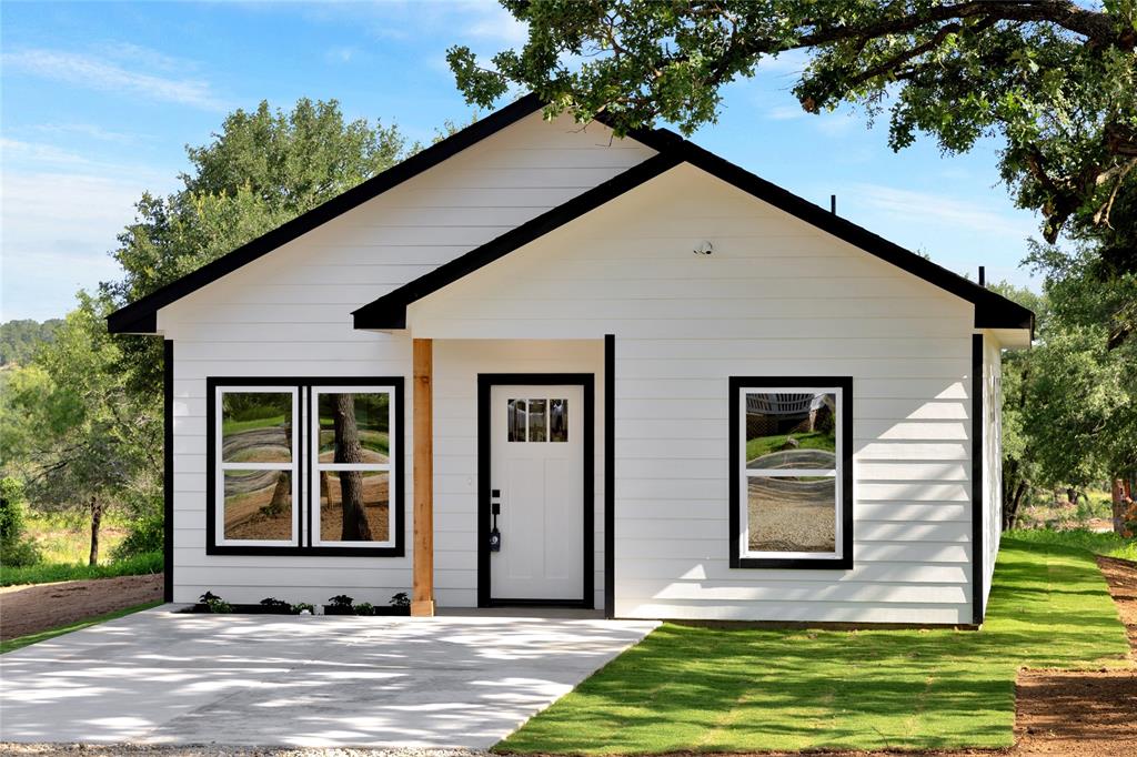 815 Southwest 28th Street Mineral Wells, TX 76067 - Photo 4 of 40 a front view of a house with a yard