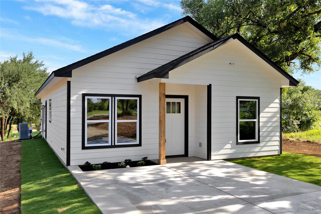 815 Southwest 28th Street Mineral Wells, TX 76067 - Photo 5 of 40 a view of a house with a yard