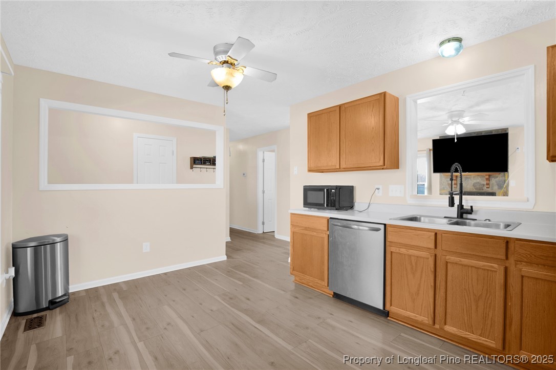 101 2 Hours Court Raeford, NC 28376 - Photo 13 of 30 a kitchen with a sink cabinets and wooden floor