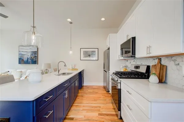 a kitchen with stainless steel appliances a sink stove and refrigerator