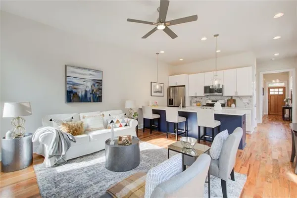 a living room with furniture and kitchen view