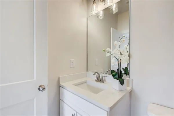 a bathroom with a sink vanity and a mirror