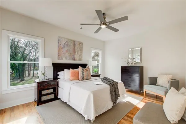 a bedroom with a bed and wooden floor