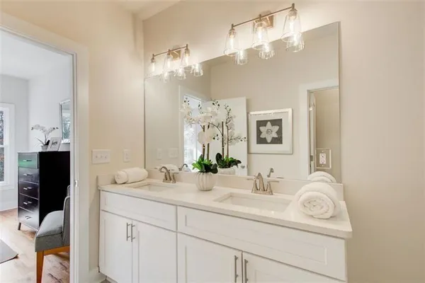 a bathroom with a sink vanity and a mirror