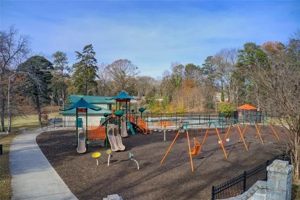 a view of a swimming pool with a patio and a yard