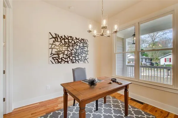 a view of a workspace with furniture and a window