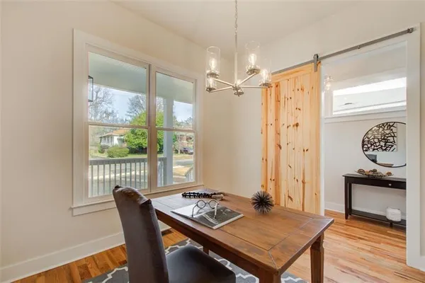 a view of a dining room with furniture window and wooden floor