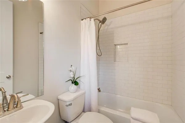 a bathroom with a toilet sink and shower