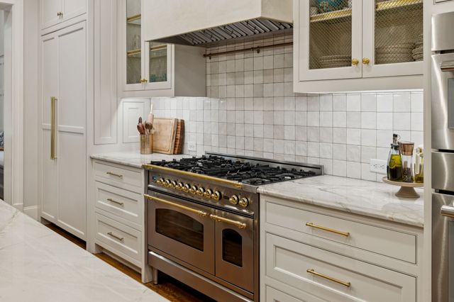 a view of a hallway with wooden floor and windows