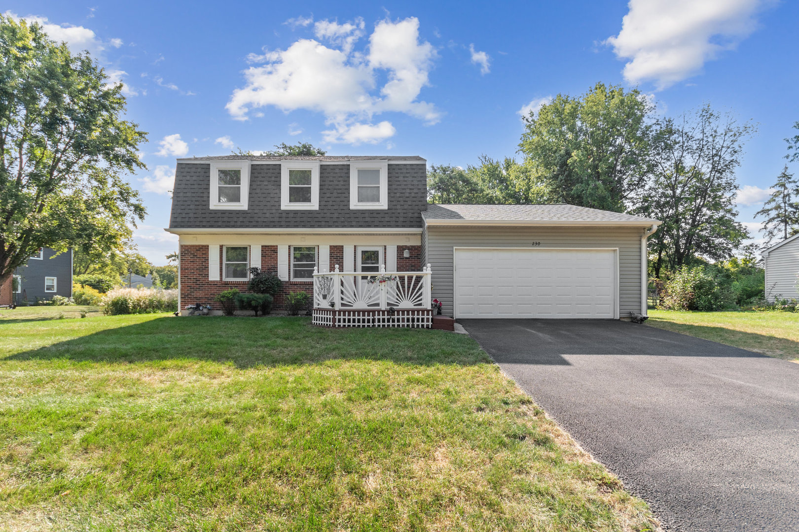 230 Ridgefield Lane Naperville, IL 60565 - Photo 1 of 26 a view of a yard in front of a house with large trees