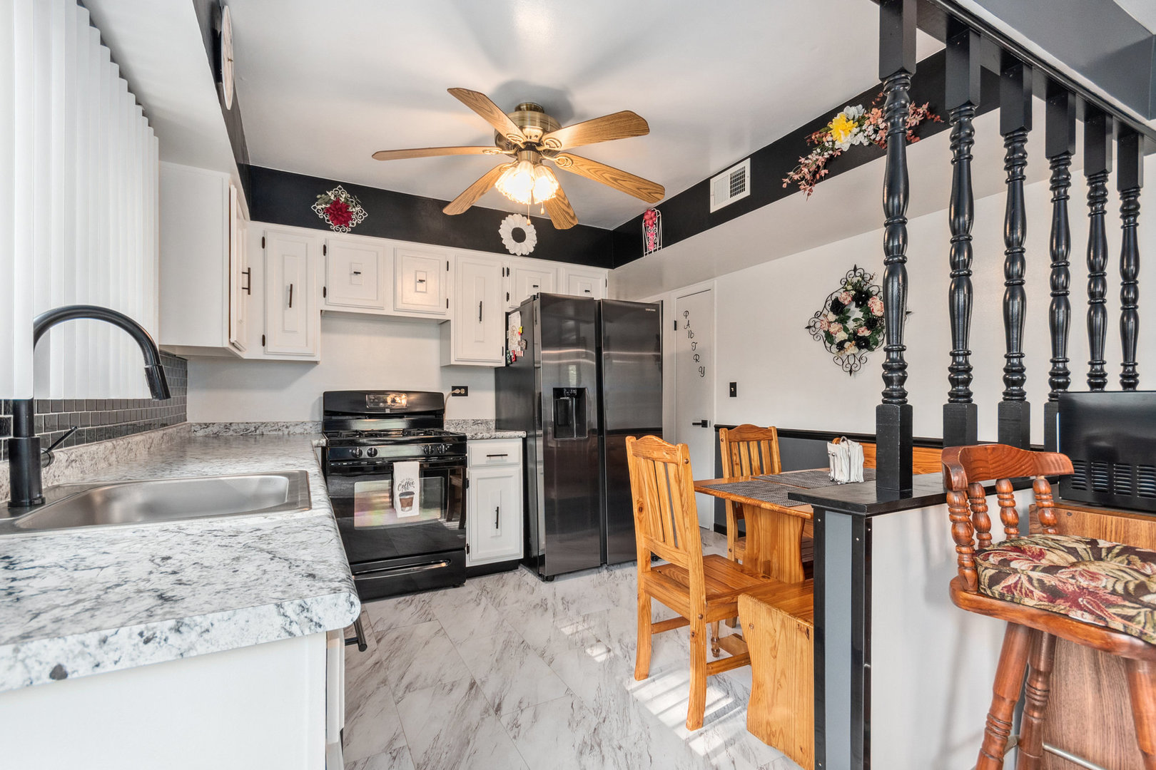 230 Ridgefield Lane Naperville, IL 60565 - Photo 8 of 26 a kitchen with stainless steel appliances kitchen island granite countertop a refrigerator a stove a microwave oven with a dining table and chairs with wooden floor