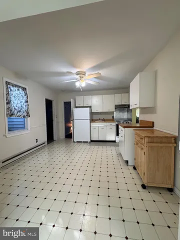a kitchen with a cabinets and a stove top oven