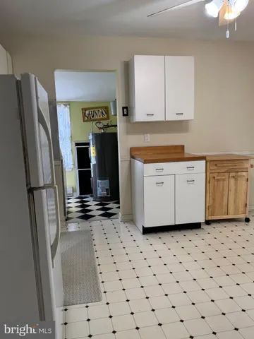 a kitchen with granite countertop a refrigerator sink and microwave