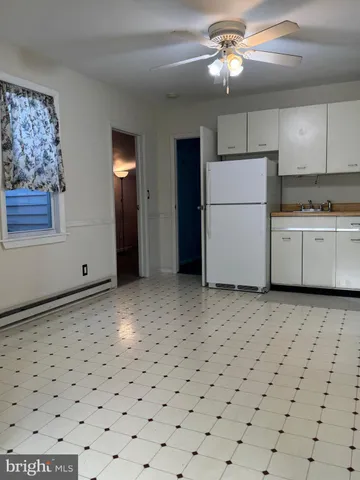 a kitchen with a refrigerator and a stove