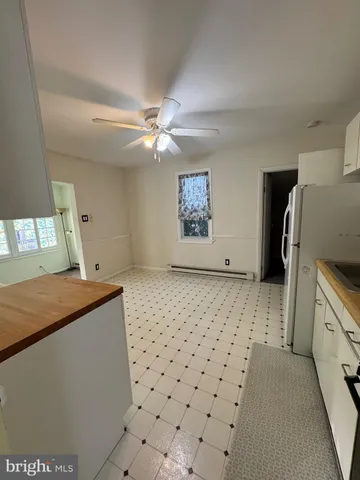 an empty room with a window and fireplace