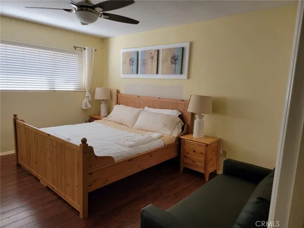 a bed sitting in a bedroom next to a window