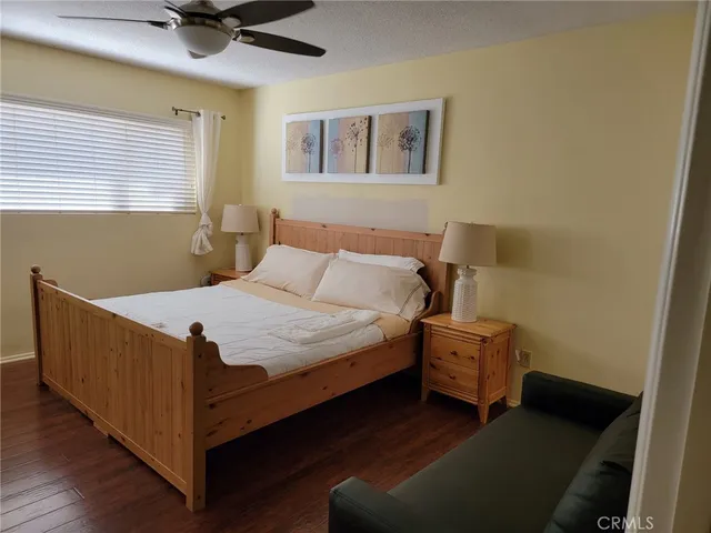 a bed sitting in a bedroom next to a window