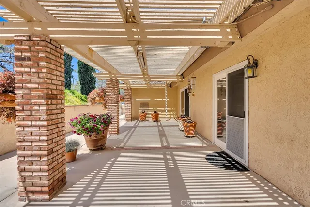 a view of a balcony with furniture and flowers