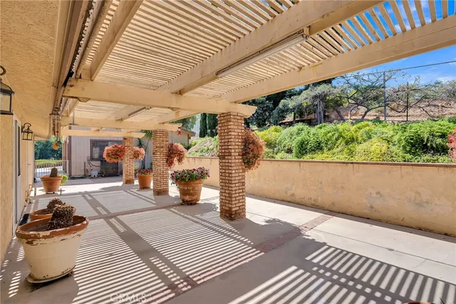 a view of a patio with dining table and chairs with wooden floor and fence