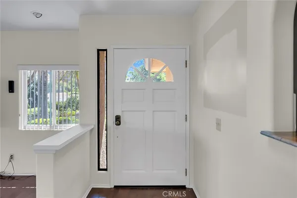 a view of an entryway with wooden floor