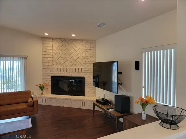a living room with furniture flat screen tv and a fireplace