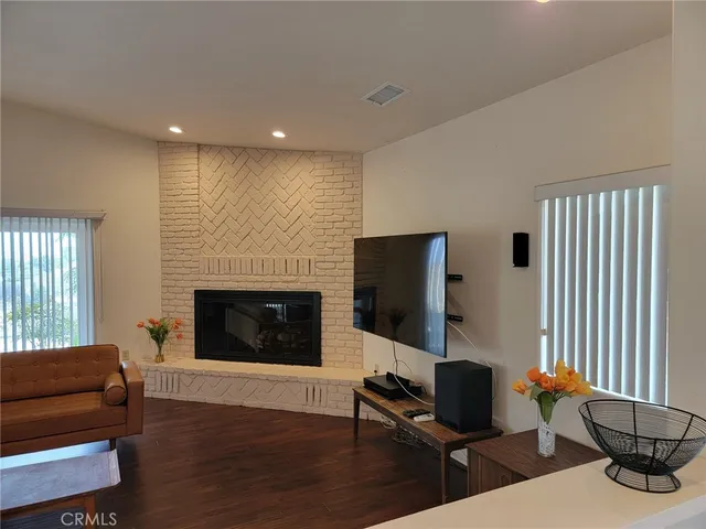a living room with furniture flat screen tv and a fireplace