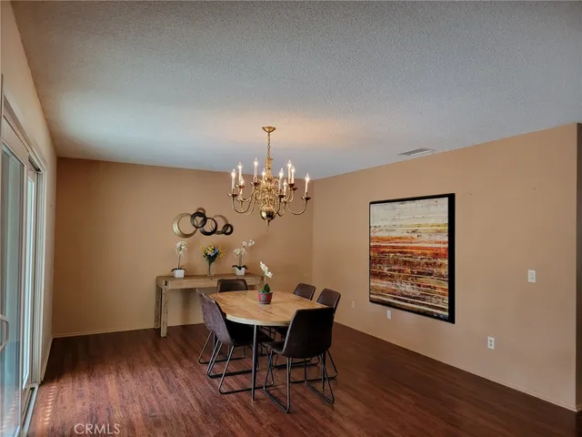 a dining room with furniture and wooden floor