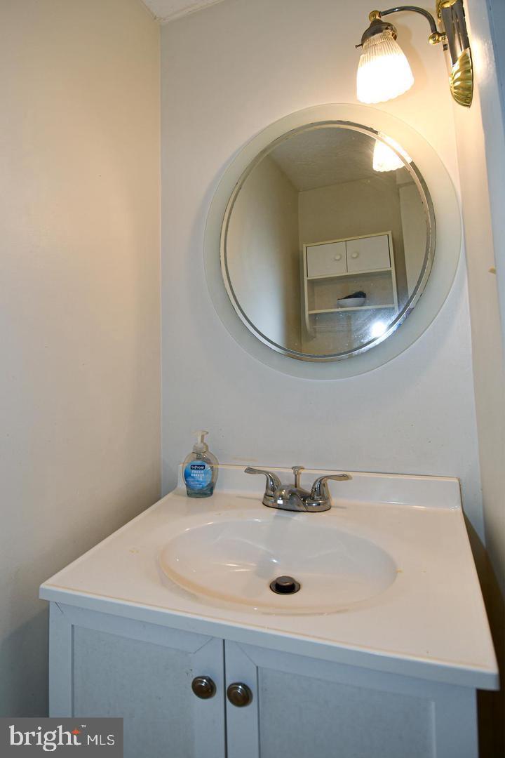 8417 Cedar Falls Court Springfield, VA 22153 - Photo 15 of 34 a bathroom with a sink and a mirror