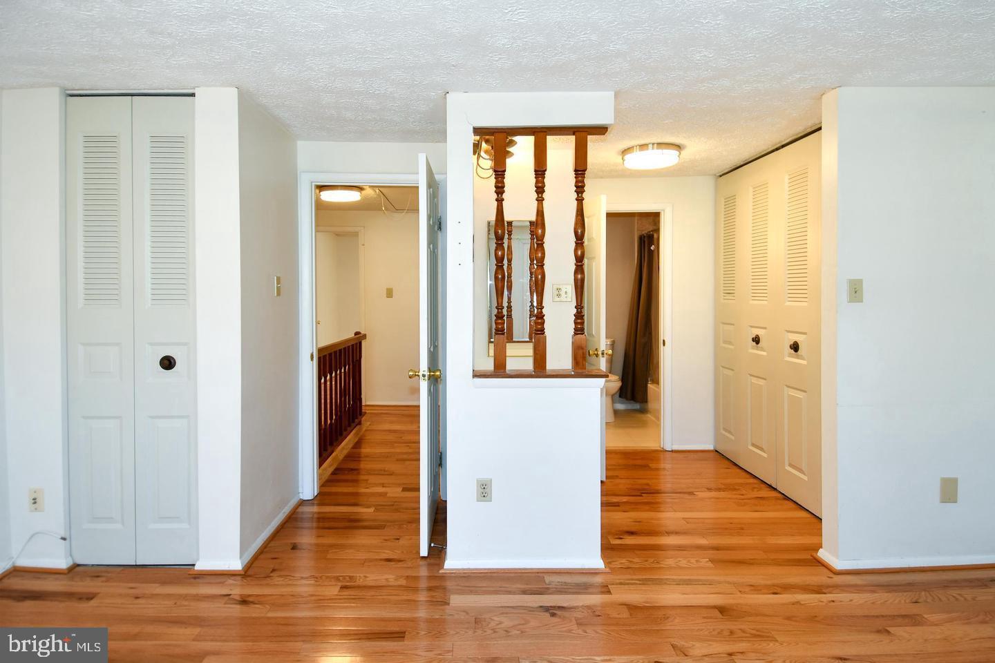 8417 Cedar Falls Court Springfield, VA 22153 - Photo 19 of 34 a view of a hallway with wooden floor and staircase
