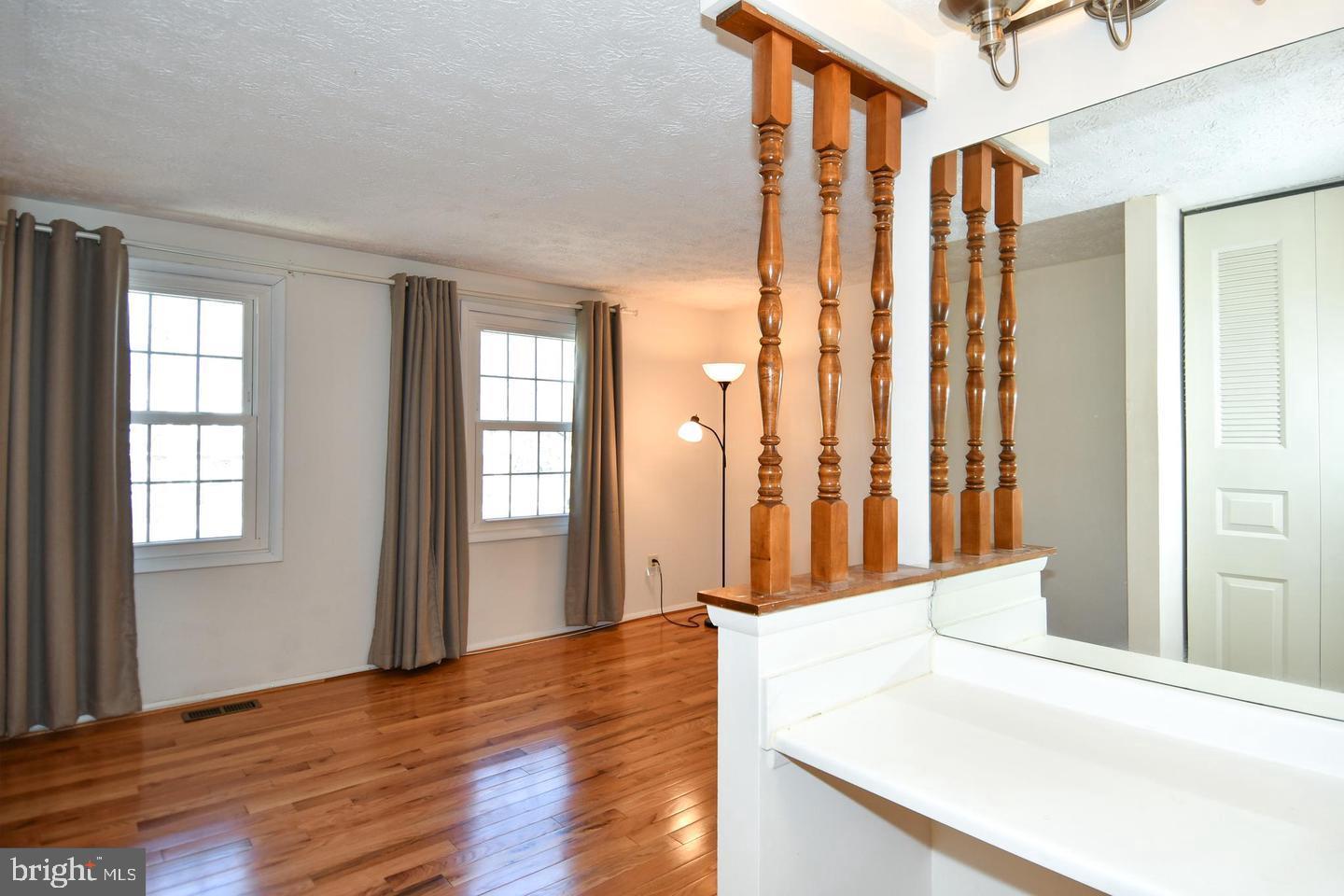 8417 Cedar Falls Court Springfield, VA 22153 - Photo 22 of 34 a view of a hallway with wooden floor and windows