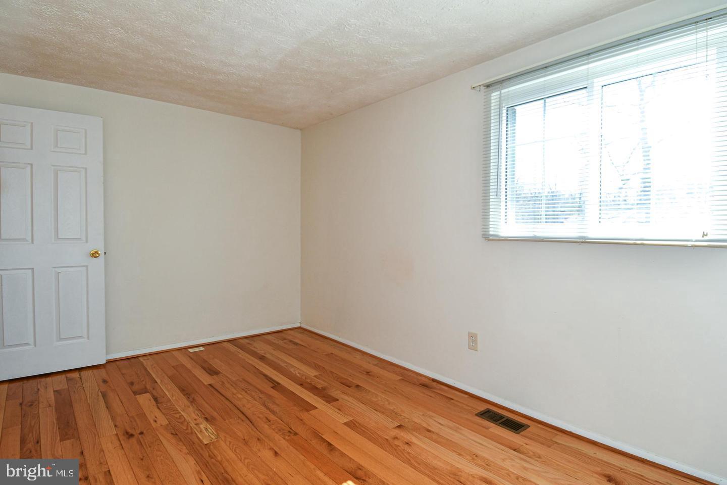 8417 Cedar Falls Court Springfield, VA 22153 - Photo 24 of 34 a view of empty room with wooden floor and fan