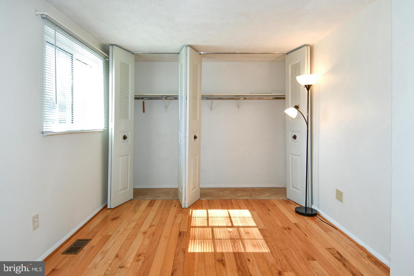 8417 Cedar Falls Court Springfield, VA 22153 - Photo 26 of 34 a view of empty room with wooden floor and fan