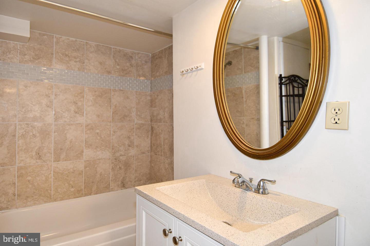 8417 Cedar Falls Court Springfield, VA 22153 - Photo 28 of 34 a bathroom with a sink and a mirror