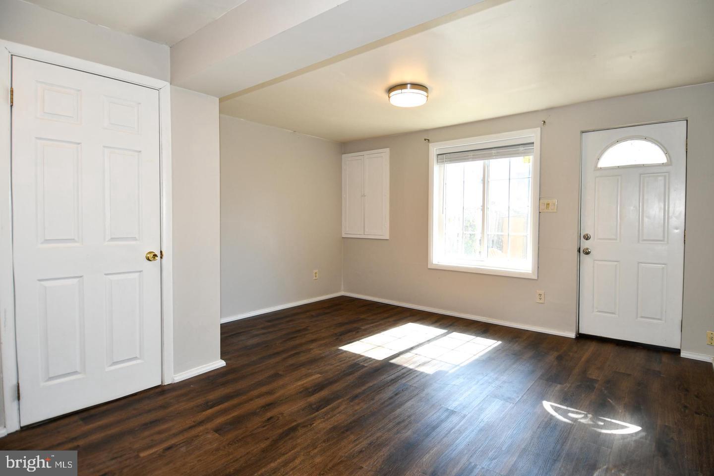 8417 Cedar Falls Court Springfield, VA 22153 - Photo 29 of 34 an empty room with wooden floor and windows