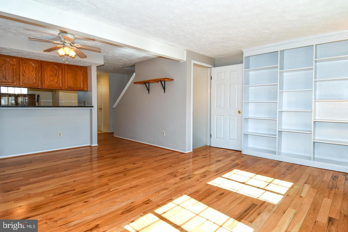 8417 Cedar Falls Court Springfield, VA 22153 - Photo 5 of 34 a view of empty room with wooden floor and fan