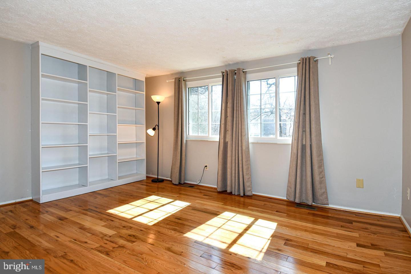 8417 Cedar Falls Court Springfield, VA 22153 - Photo 7 of 34 a view of a room with wooden floor and windows