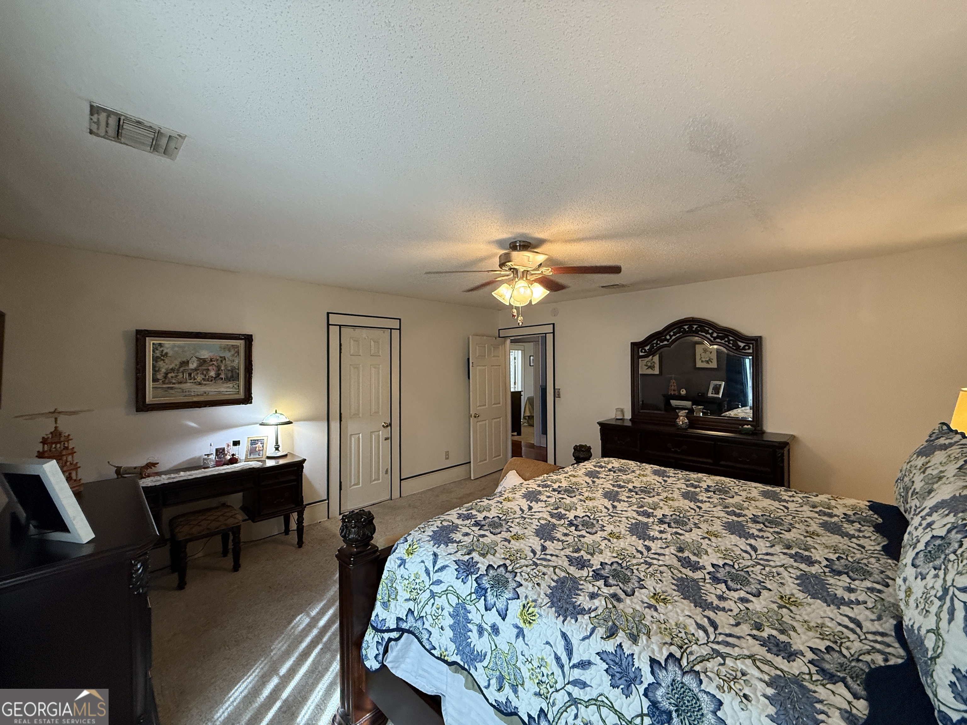 219 North College Street Pembroke, GA 31321 - Photo 13 of 24 a bedroom with a bed a dresser and painting on the wall