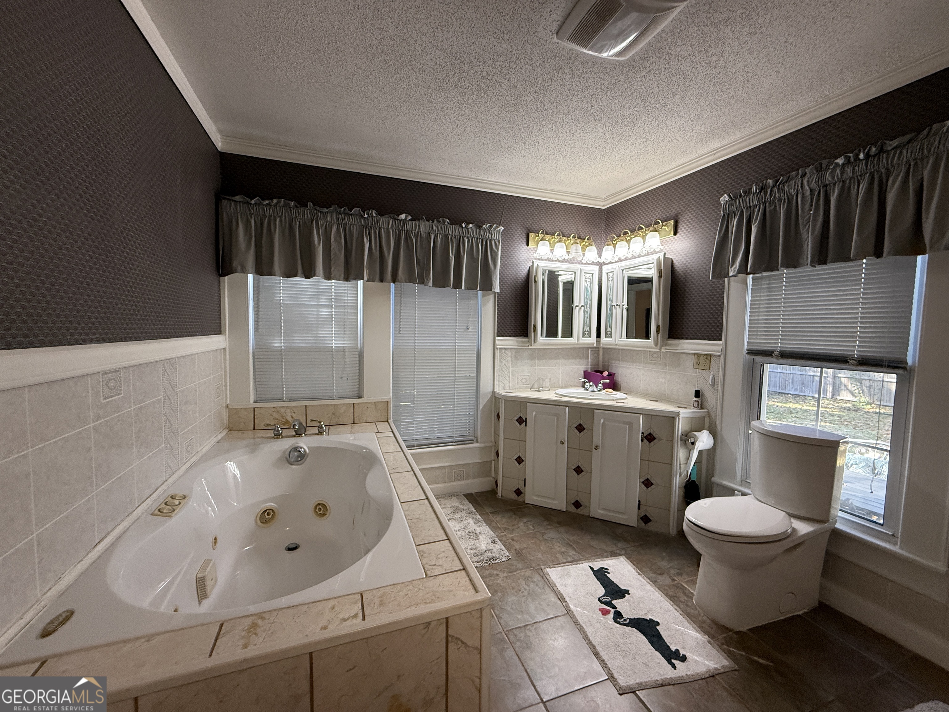 219 North College Street Pembroke, GA 31321 - Photo 14 of 24 a bathroom with a sink a toilet and bathtub