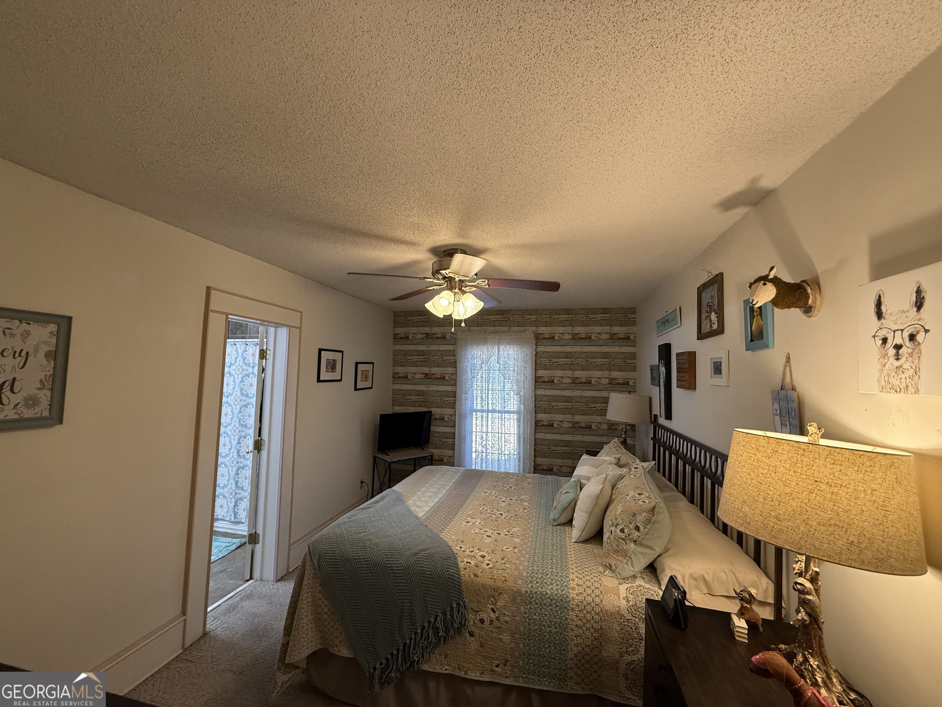 219 North College Street Pembroke, GA 31321 - Photo 15 of 24 a bedroom with a bed and a chandelier