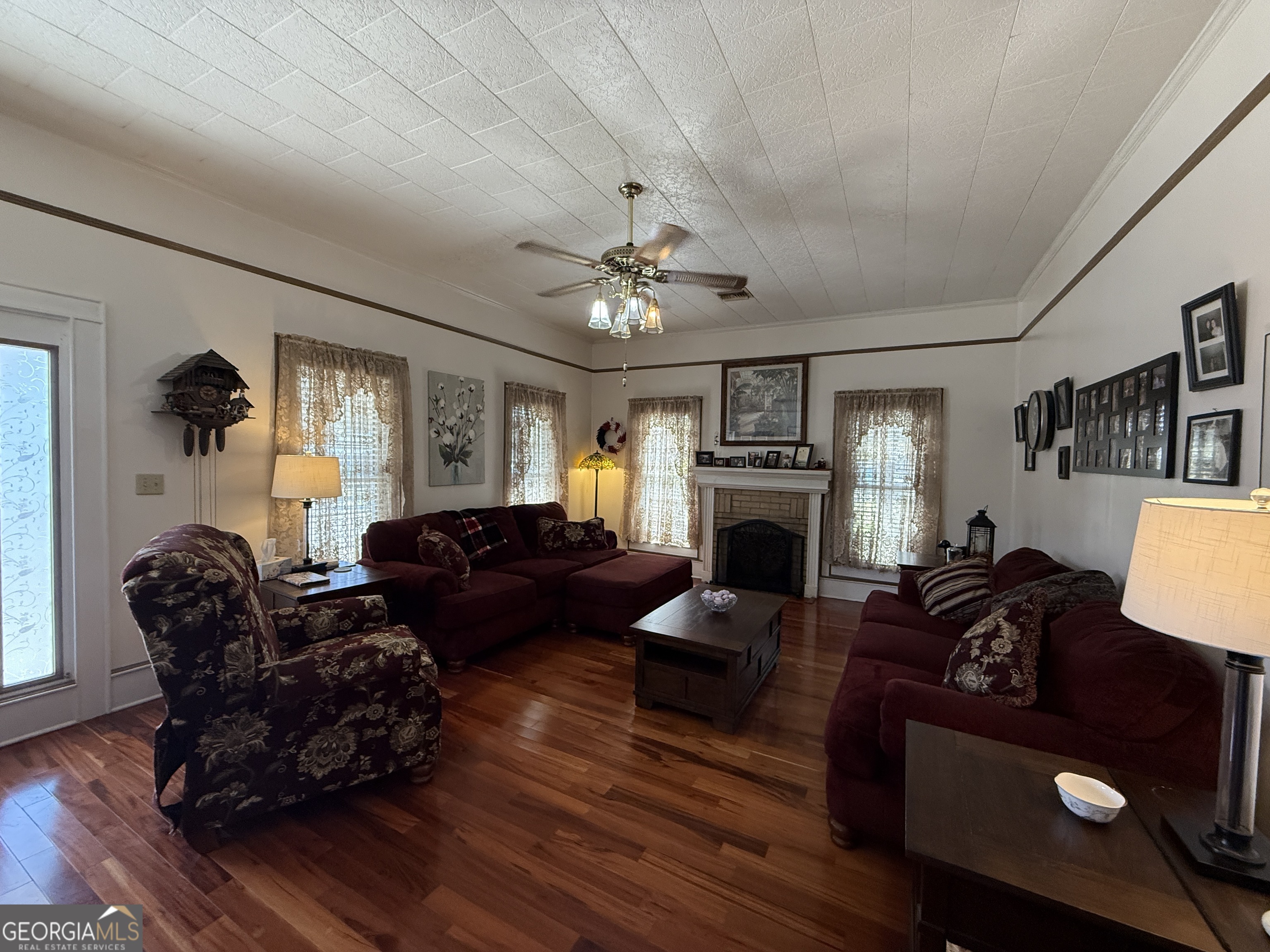 219 North College Street Pembroke, GA 31321 - Photo 5 of 24 a living room with furniture and a fireplace