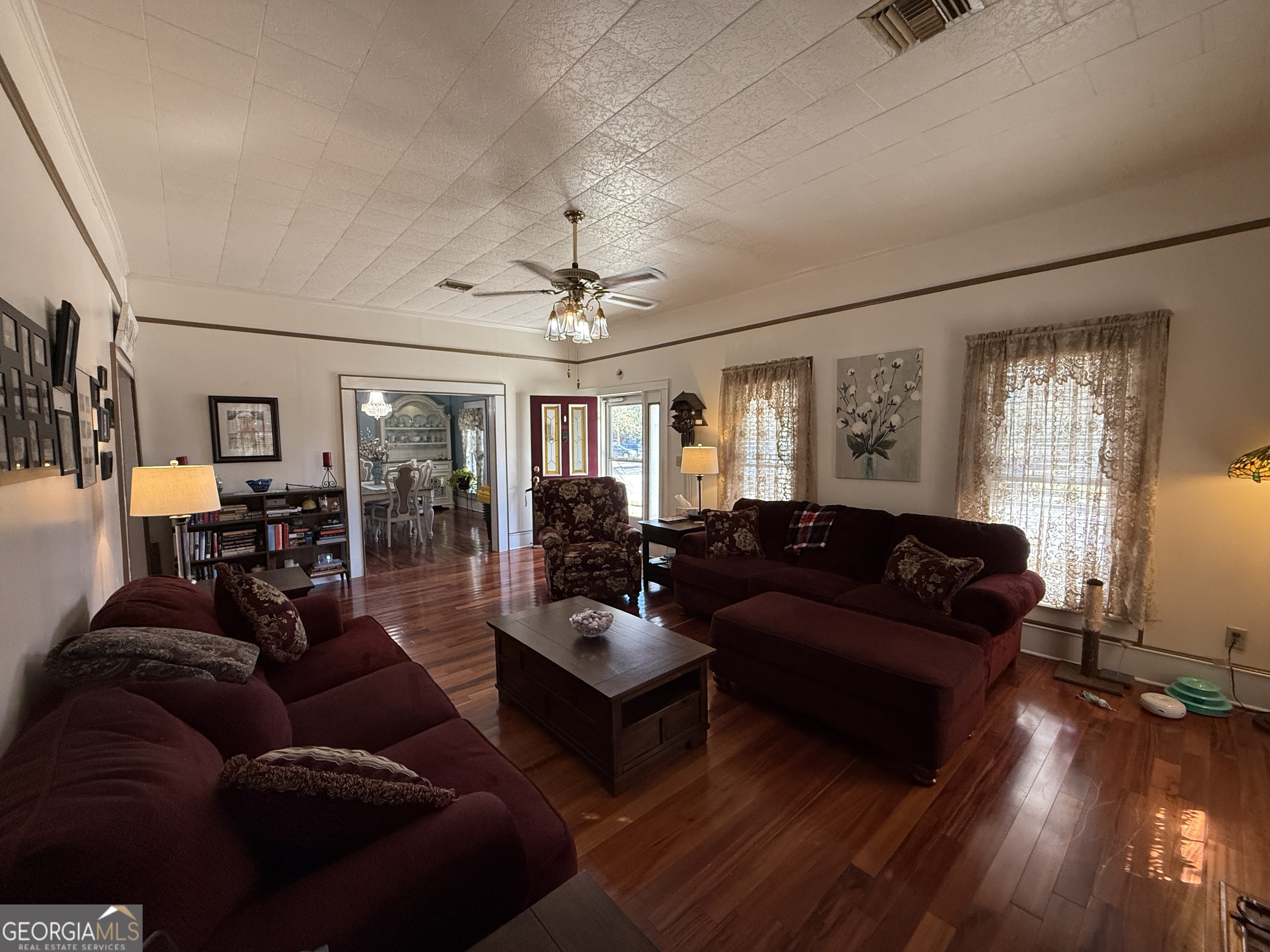 219 North College Street Pembroke, GA 31321 - Photo 6 of 24 a living room with furniture and wooden floor