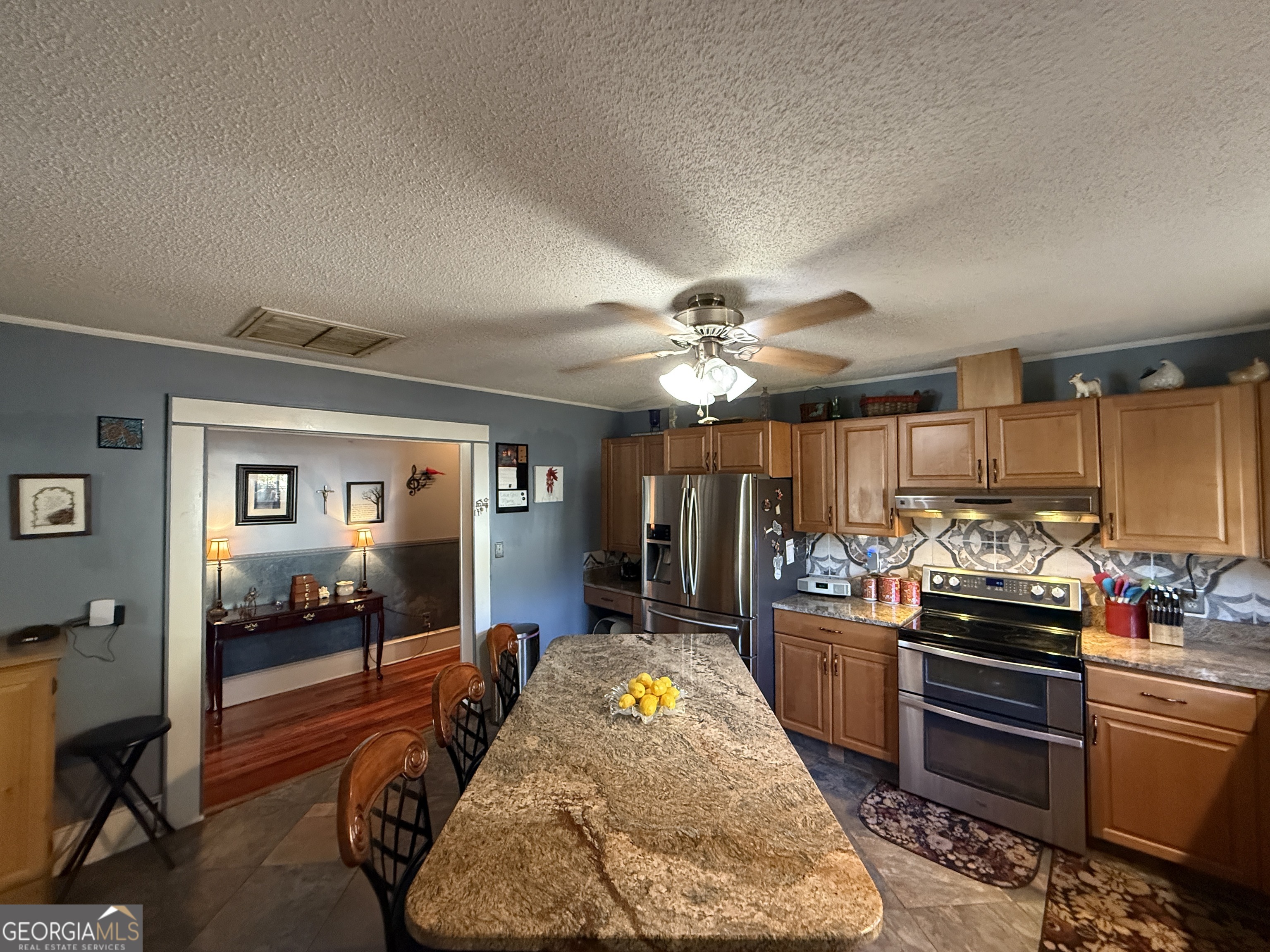 219 North College Street Pembroke, GA 31321 - Photo 7 of 24 a bedroom with furniture and a kitchen