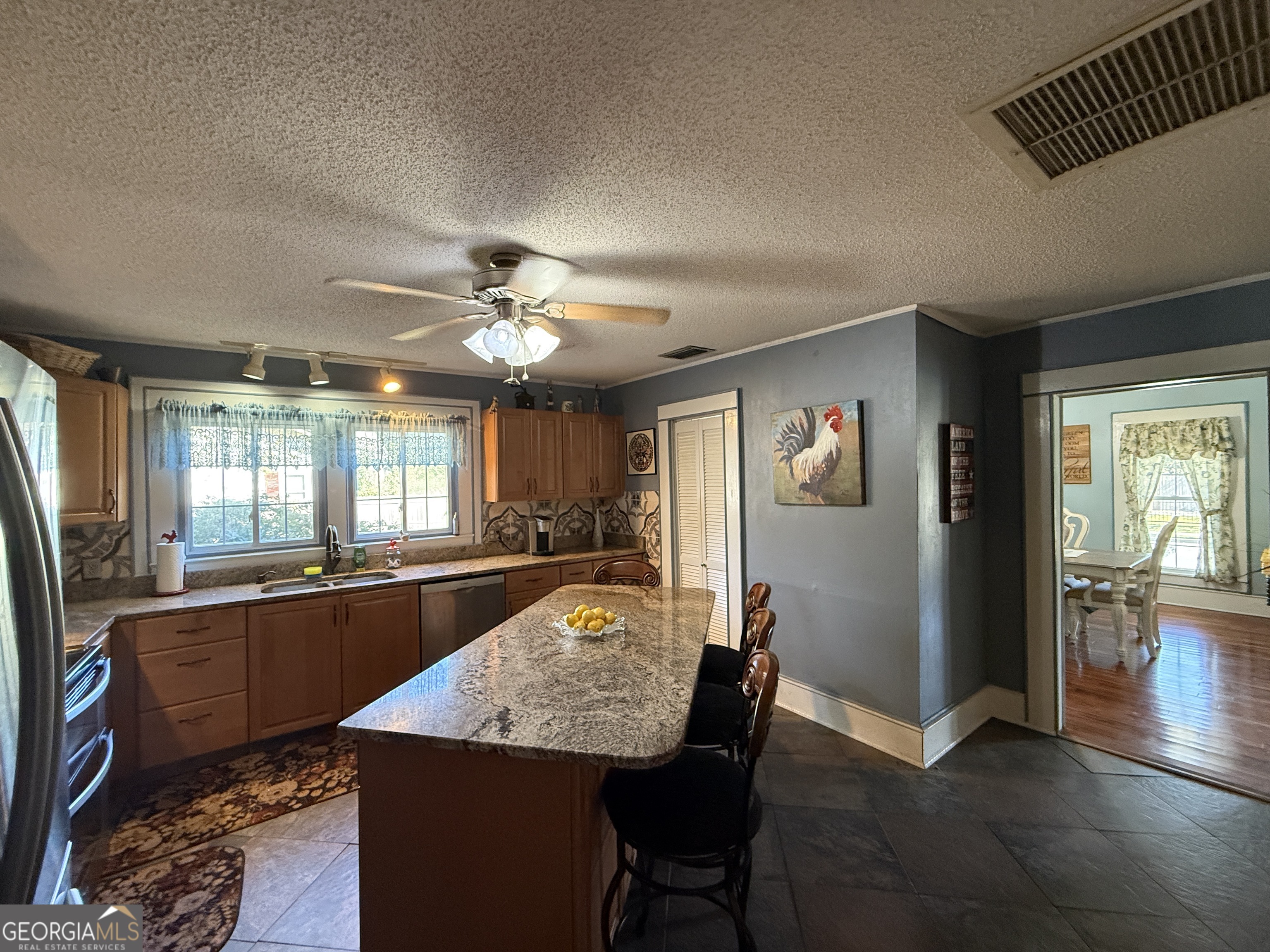 219 North College Street Pembroke, GA 31321 - Photo 10 of 24 a dining room with wooden floor and chandelier