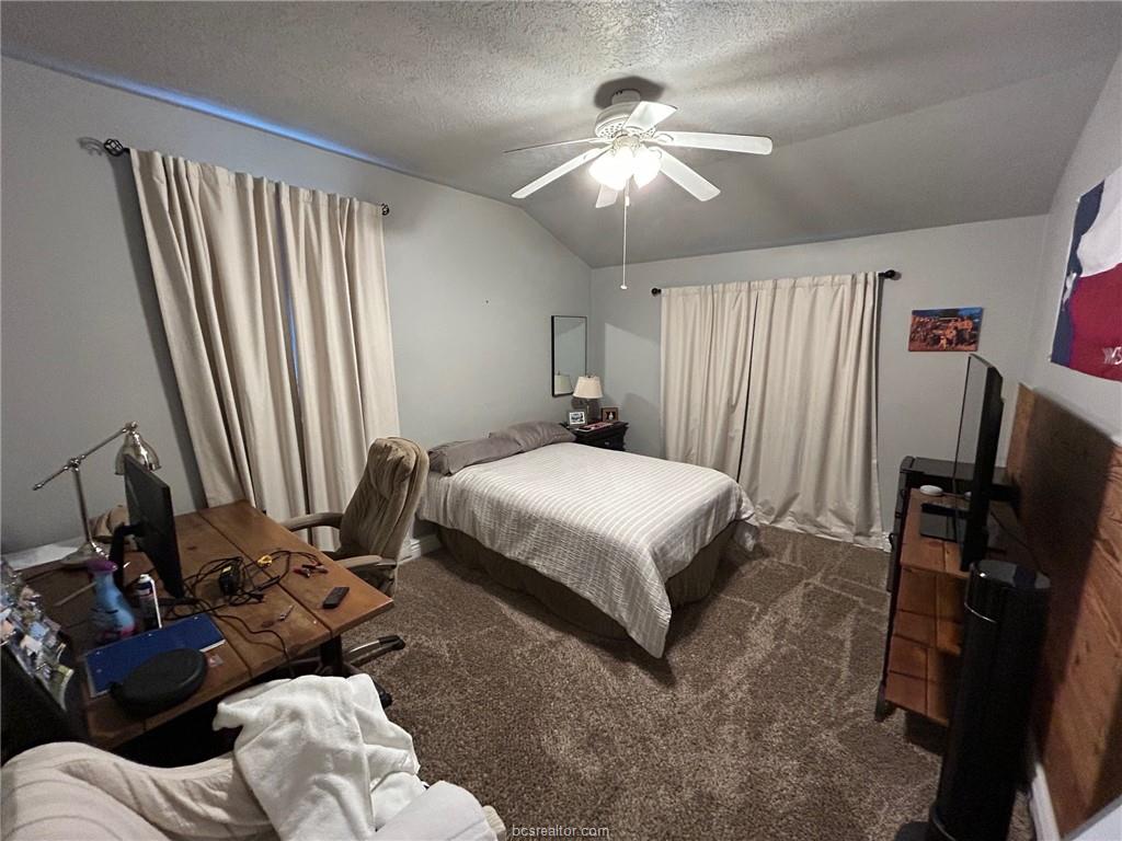 710 Enfield Street Bryan, TX 77802 - Photo 13 of 19 a bedroom with a bed and a chandelier