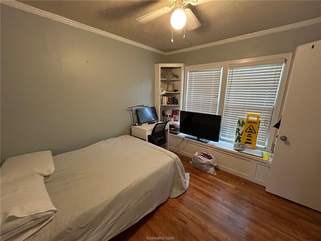 710 Enfield Street Bryan, TX 77802 - Photo 8 of 19 a bedroom with a bed and a computer on the desk