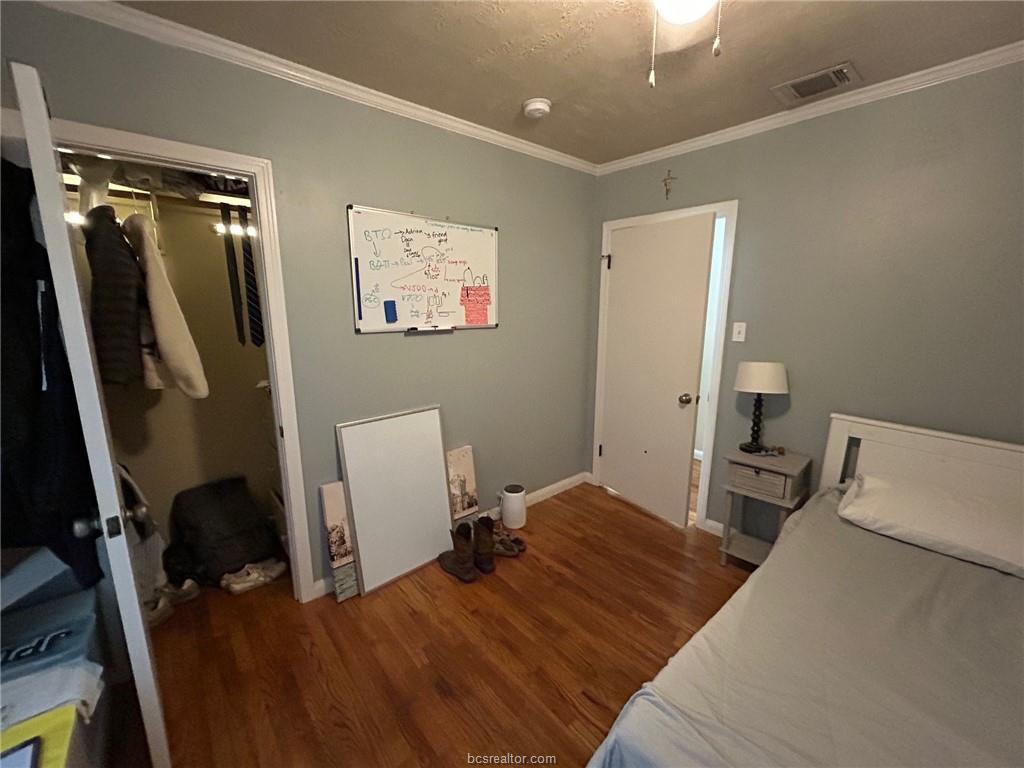 710 Enfield Street Bryan, TX 77802 - Photo 9 of 19 a bedroom with a bed and a desk