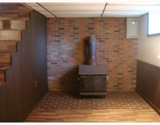 5709 Library Road Bethel Park, PA 15102 - Photo 4 of 6 Den/Family/Great Room. Finished game room with wood tone floors, wood burning stove and partial bath